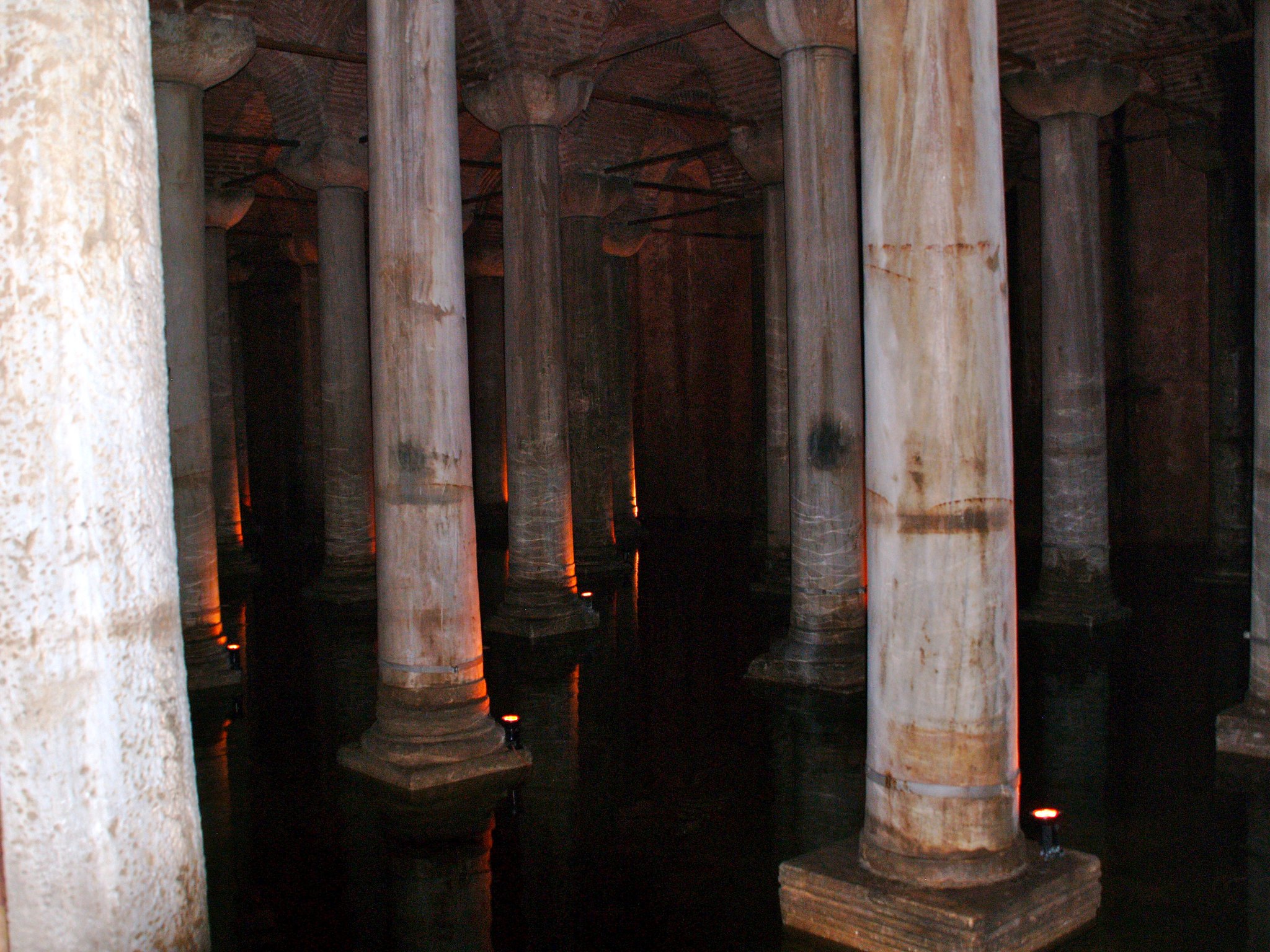 Rows of columns in the Basilica Cistern with their reflections doubling them in the water below