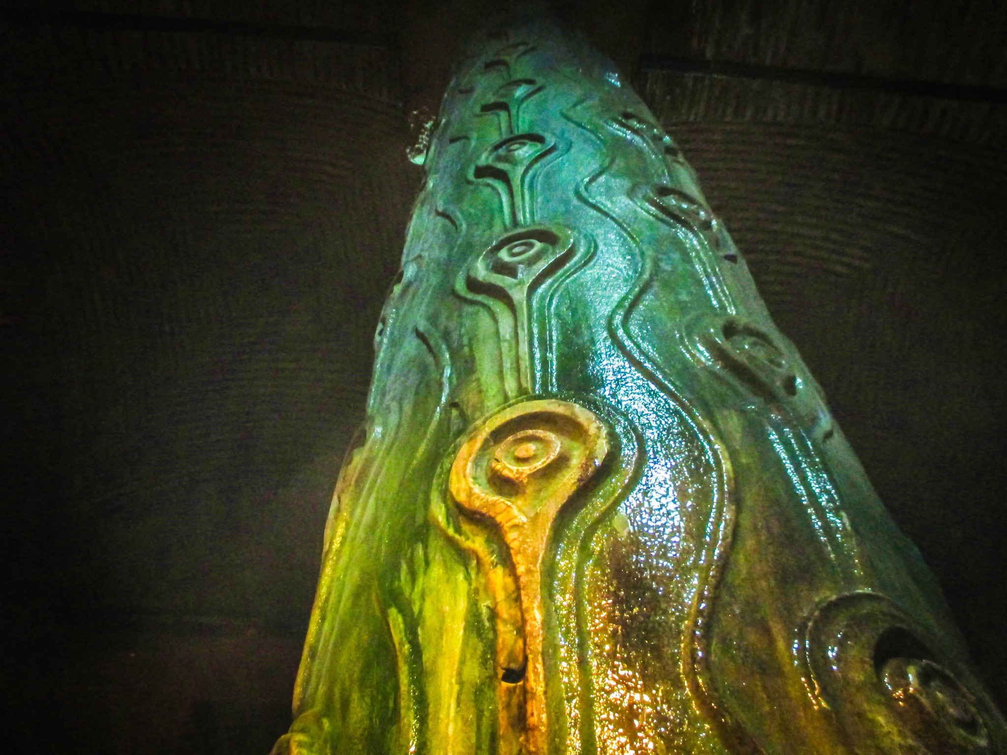 The Peacock-eyed column in the Basilica Cistern, its carved surface lit green