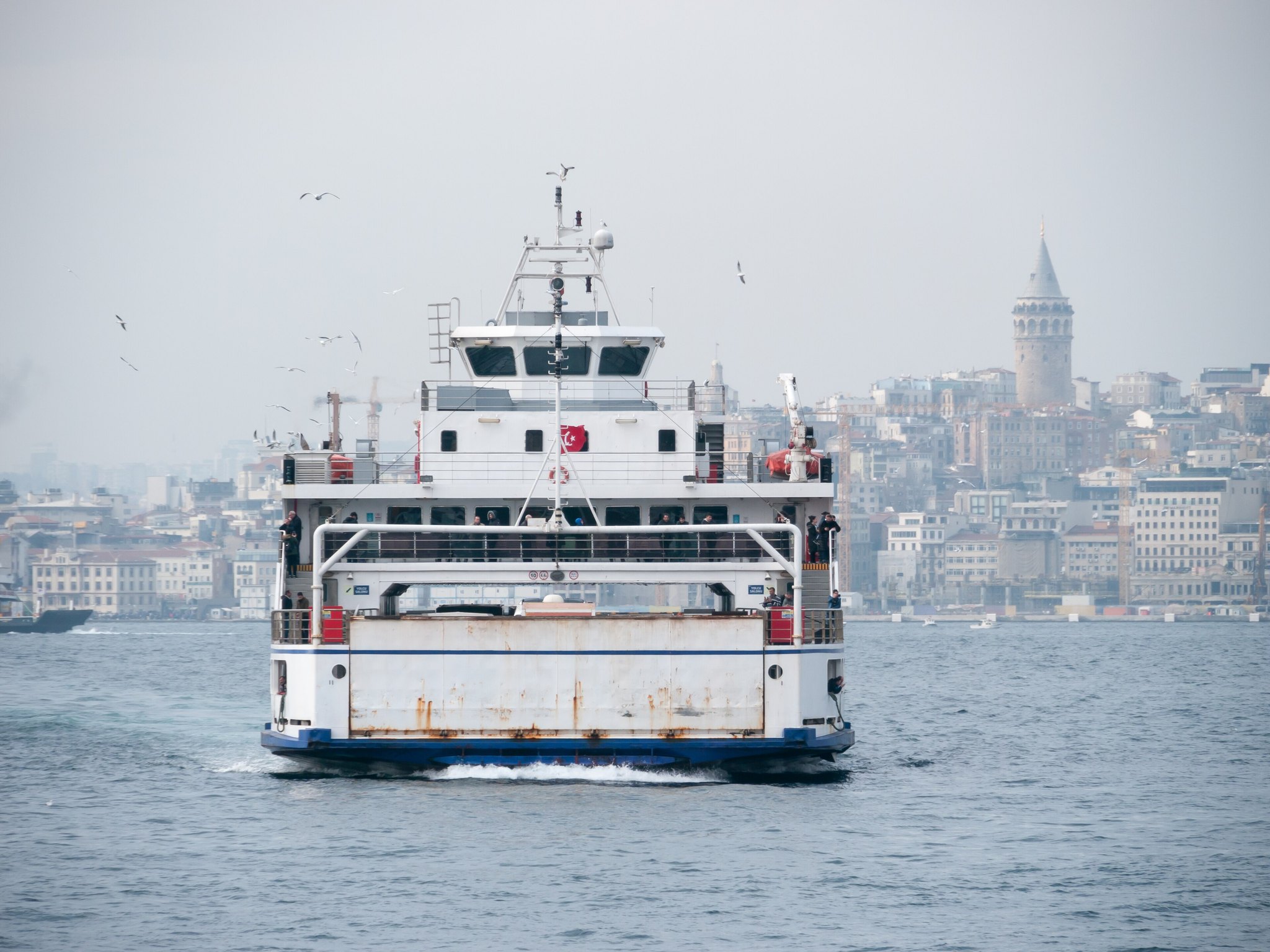 A ferry on the Bosphorus with the Galata Tower on the skyline behind it