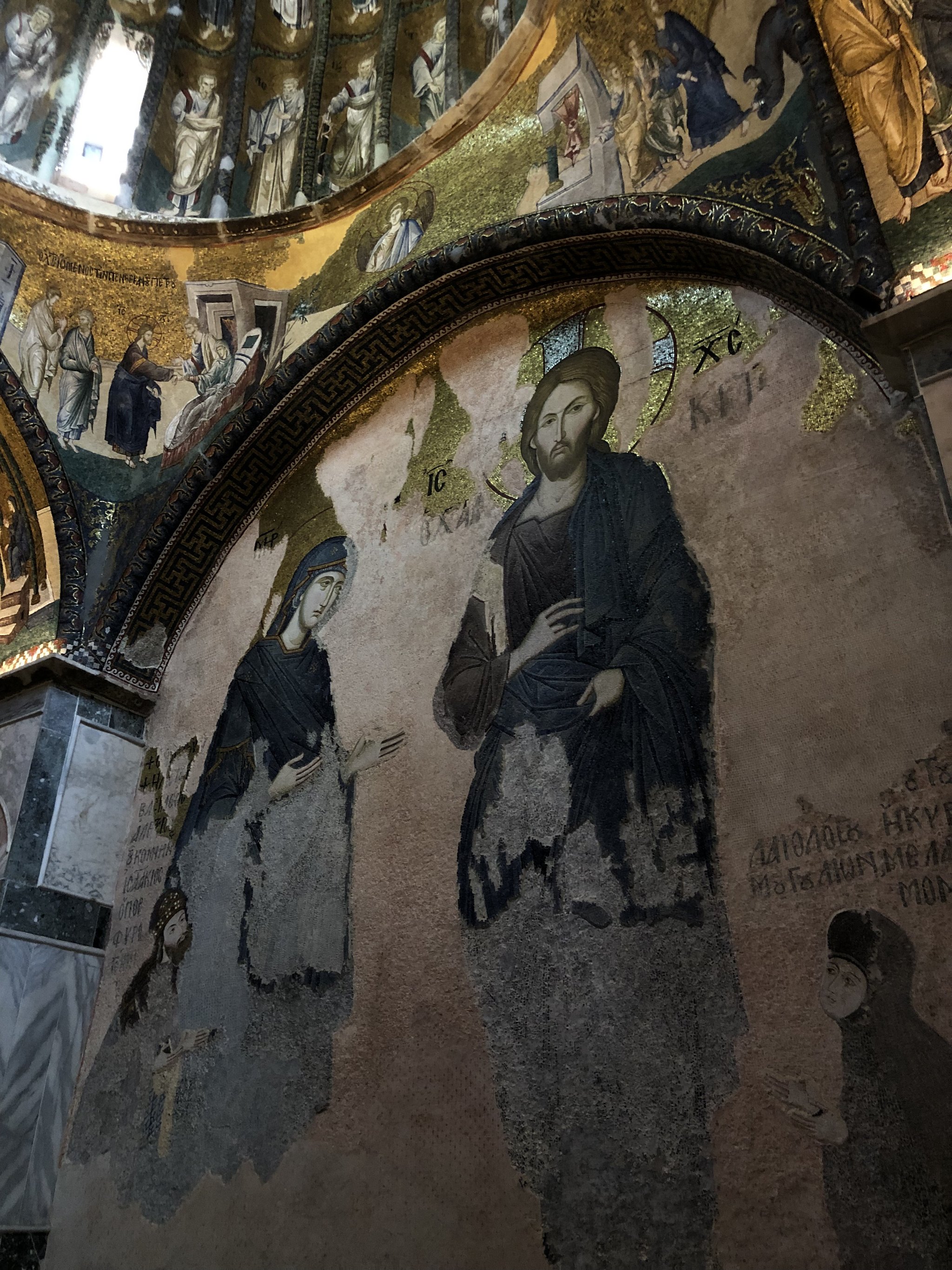 A wall fresco at Chora, a robed figure in faded ochre and blue