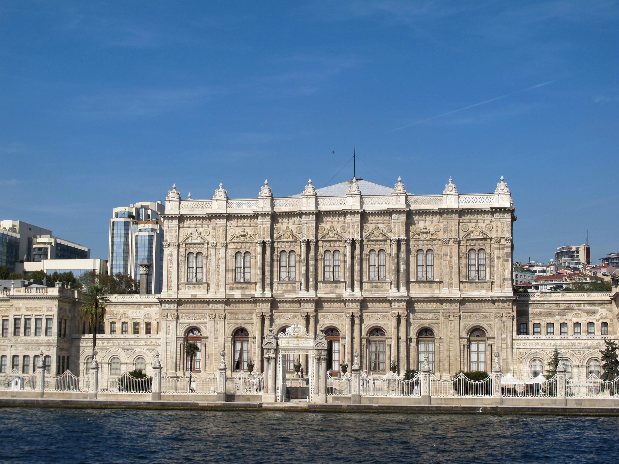The long white façade of Dolmabahce Palace along the Bosphorus, ornamented in carved stone