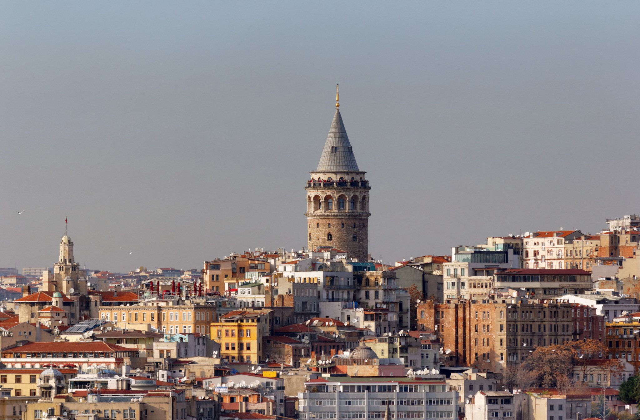 The Galata Tower rising above the packed rooftops of Beyoglu, the Golden Horn behind
