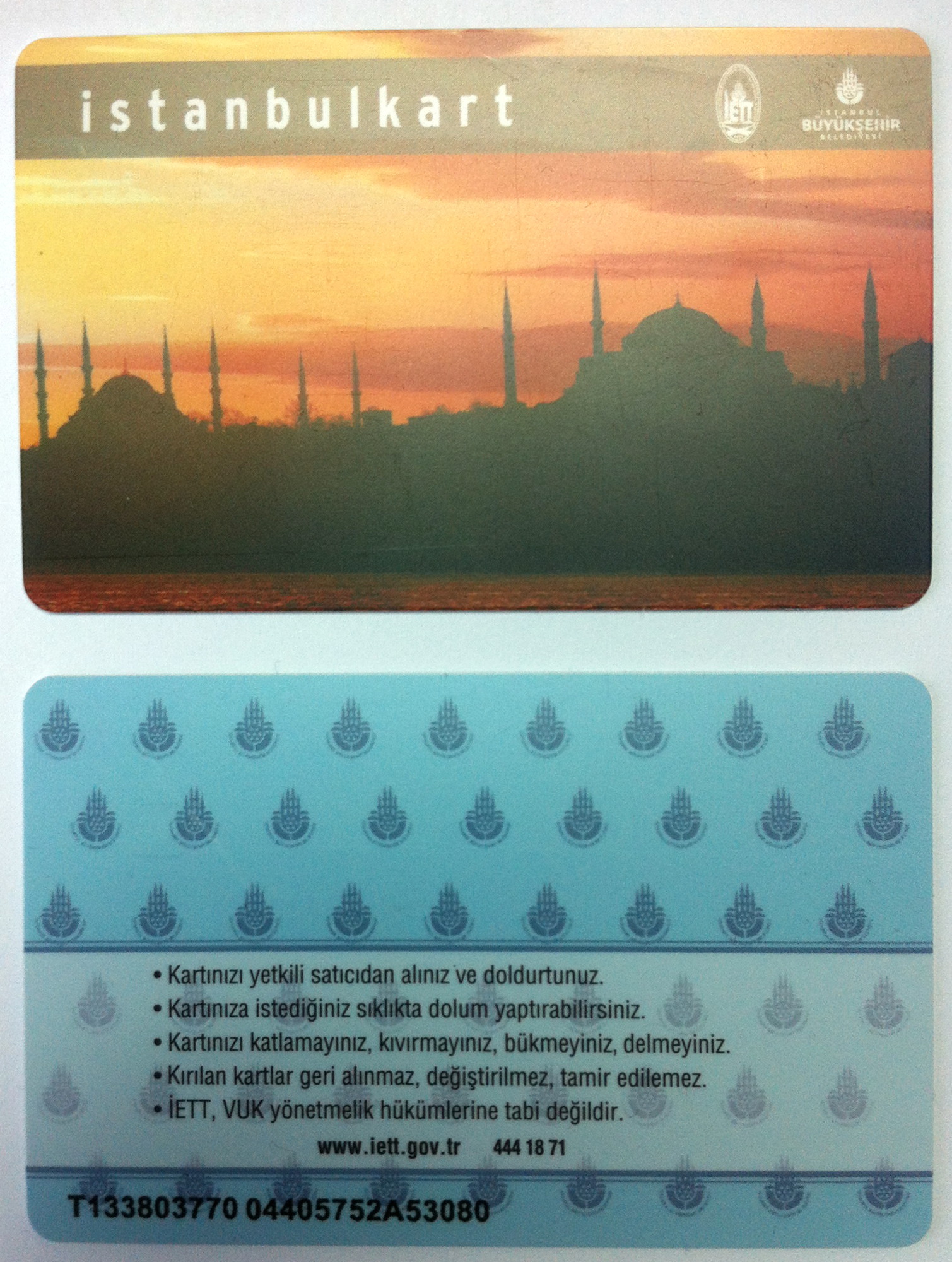 An Istanbulkart travel card held in front of a turnstile, the card that opens the tram, metro, bus, funicular and ferry gates