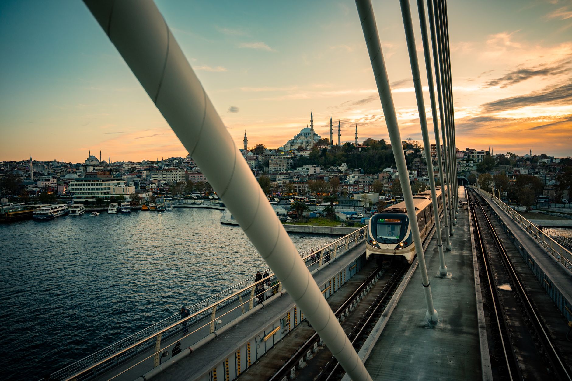 Metro train crossing Haliç Bridge in Istanbul with cityscape and water