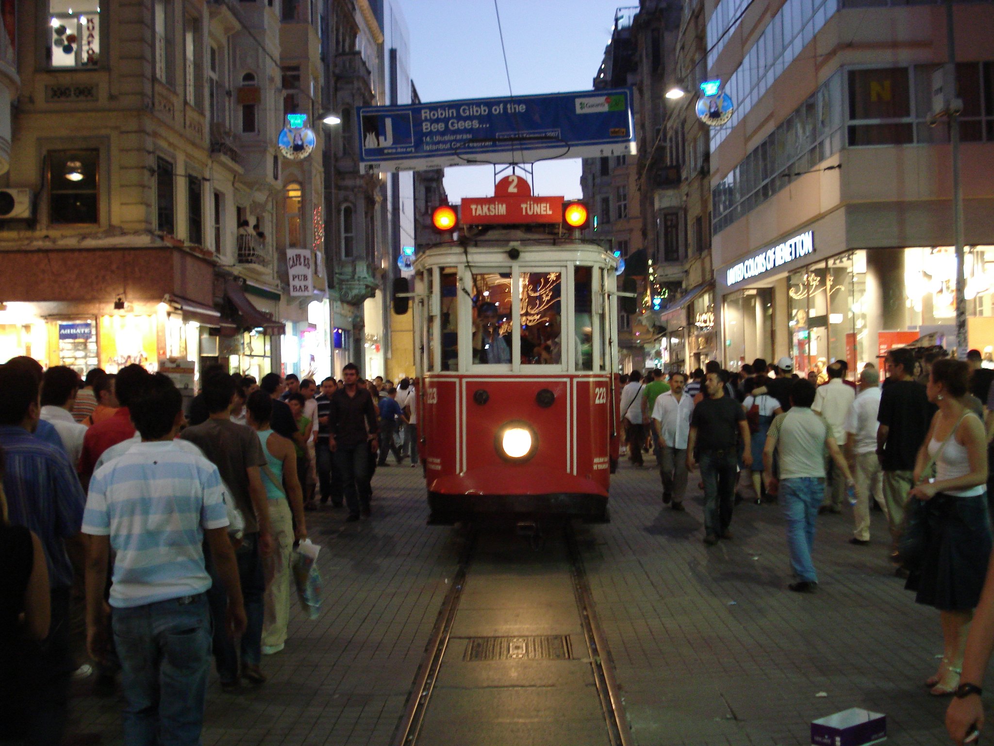 The red nostalgic tram nosing through the crowd on Istiklal Avenue