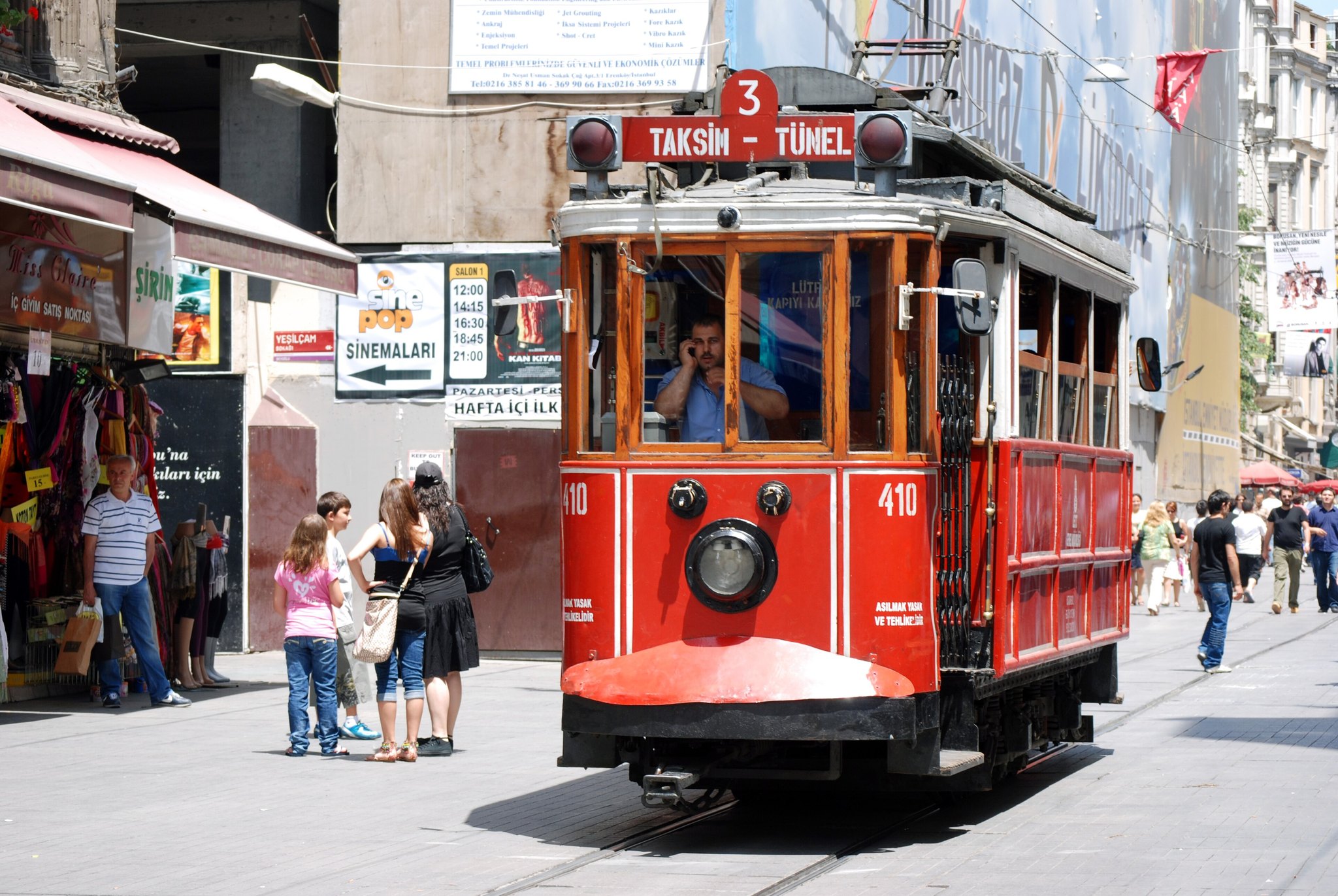 The nostalgic tram stopped on Istiklal Avenue with passengers stepping down