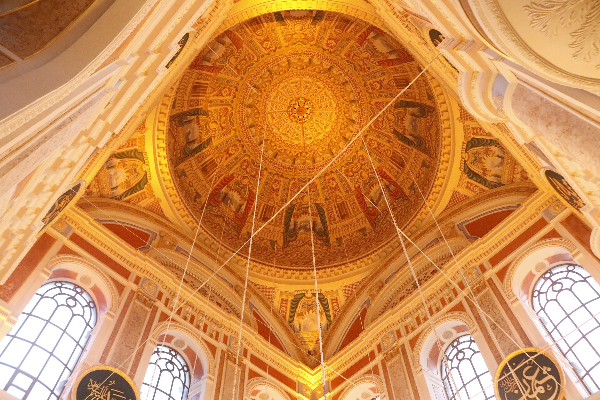 The gilded dome of Ortakoy Mosque from inside, ringed by tall windows