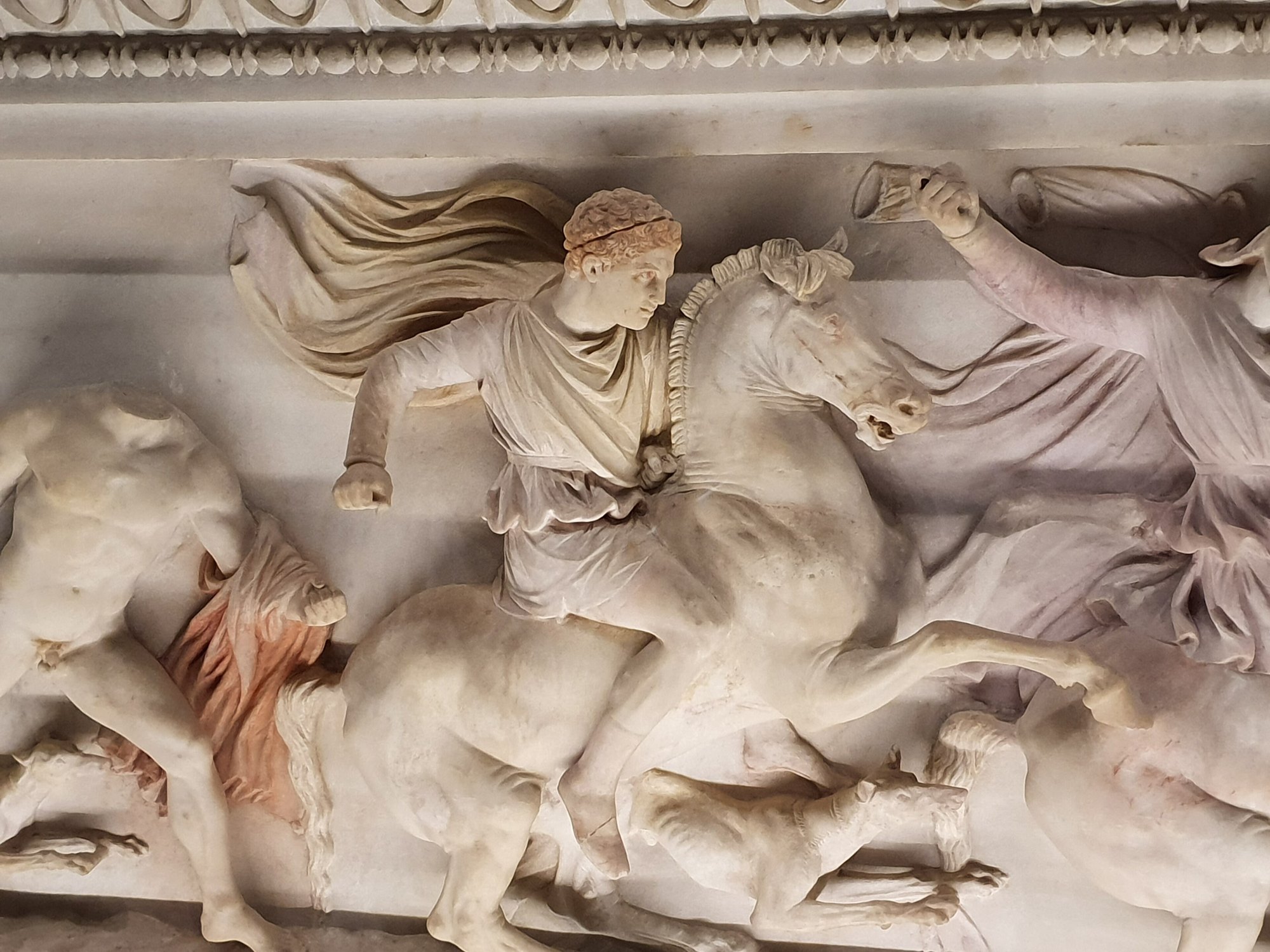 A detail of the Alexander Sarcophagus: a mounted figure among horses, carved in high relief