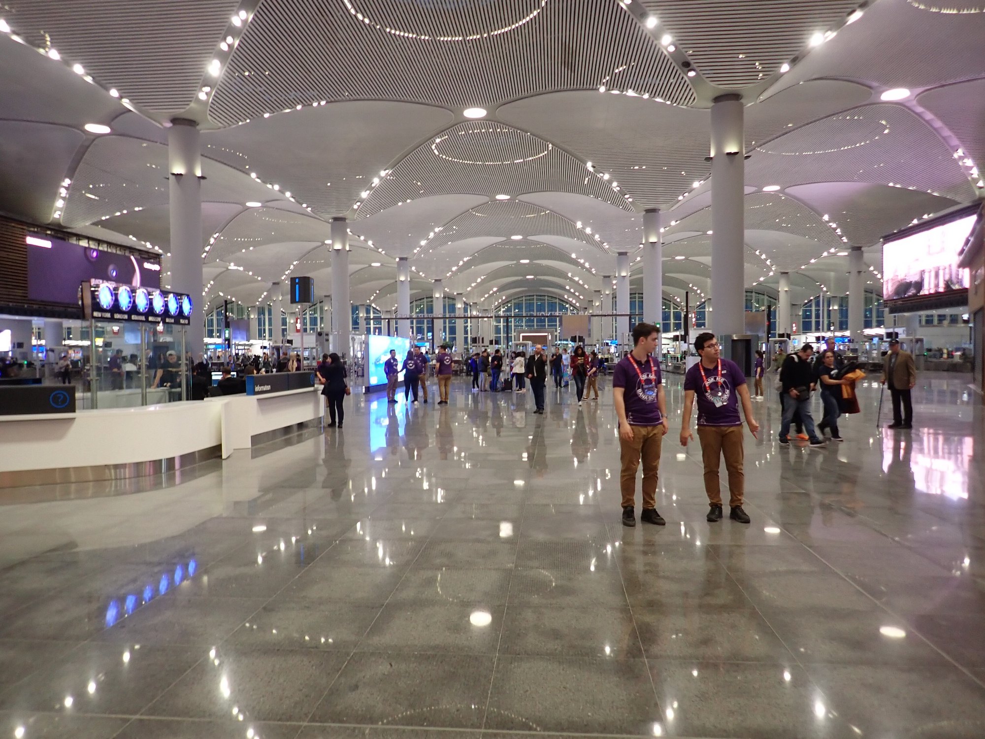 The main concourse of Istanbul Airport, its vaulted white ceiling running away above the hall