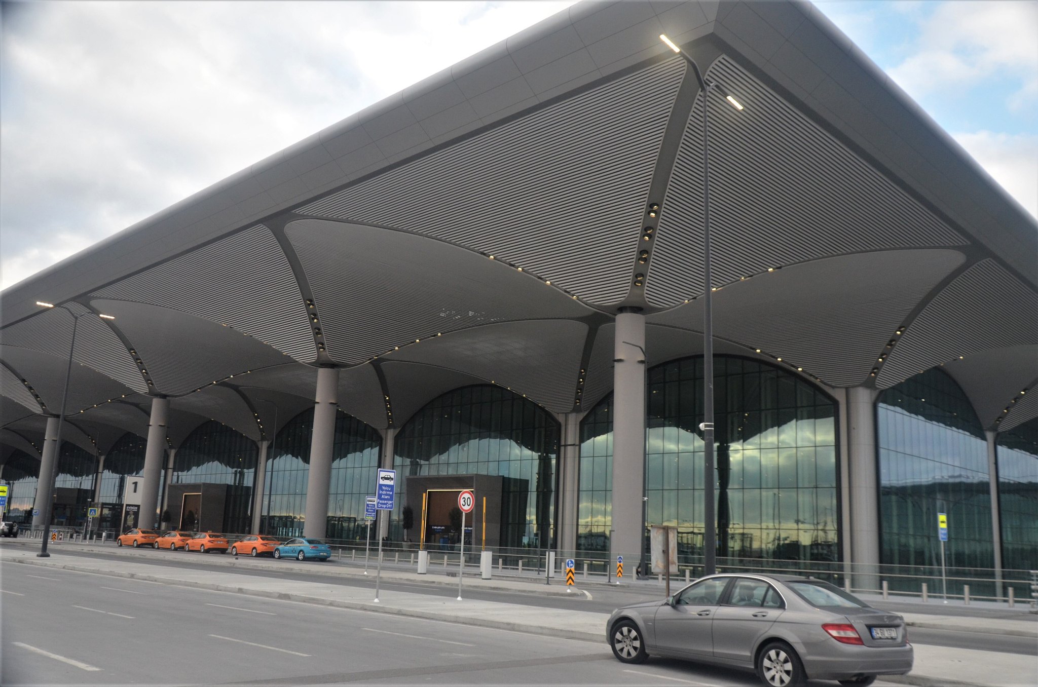 The exterior of Istanbul Airport, its white tented roof spans above the terminal frontage