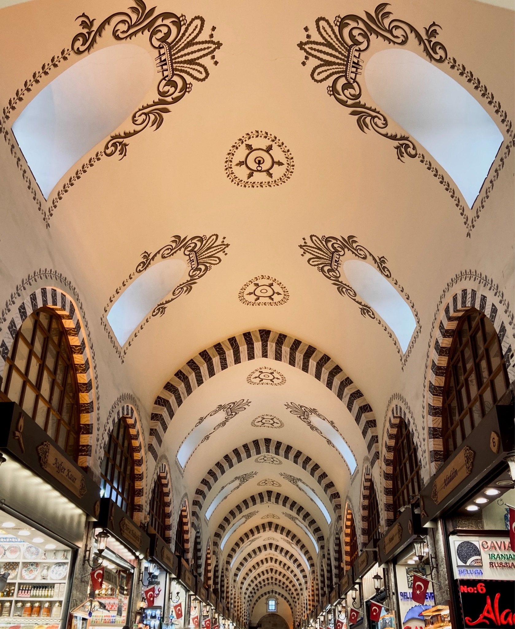 The painted vaulting of the Spice Bazaar ceiling, red and gold arabesques between the ribs
