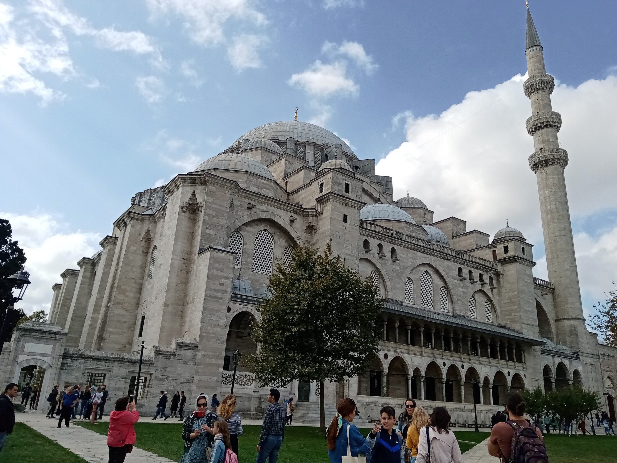 The Suleymaniye Mosque on its terrace, the great dome stepping down to half-domes, with visitors on the path