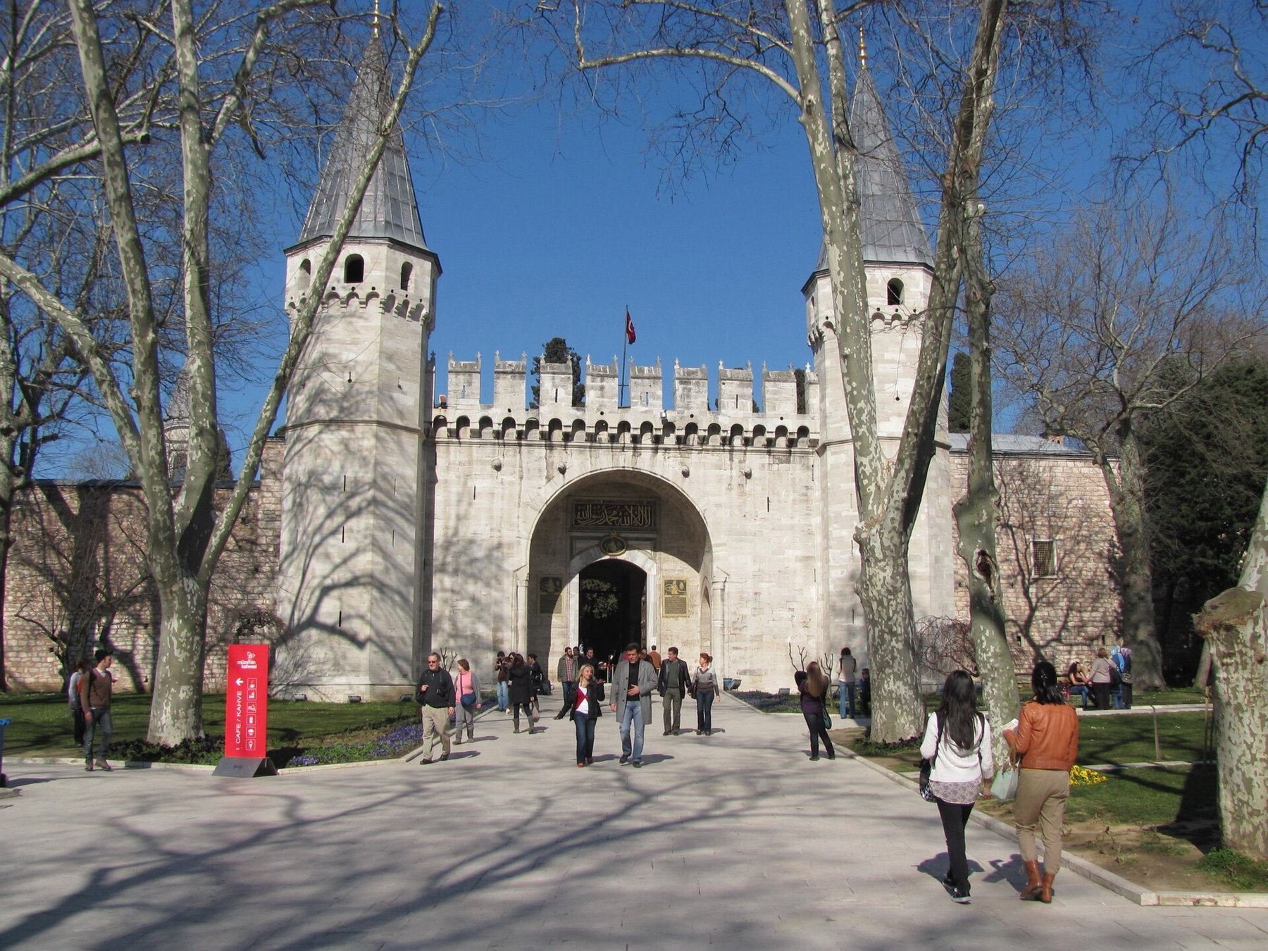 The Gate of Salutation at Topkapi Palace, its two conical towers flanking the entrance, with visitors queuing